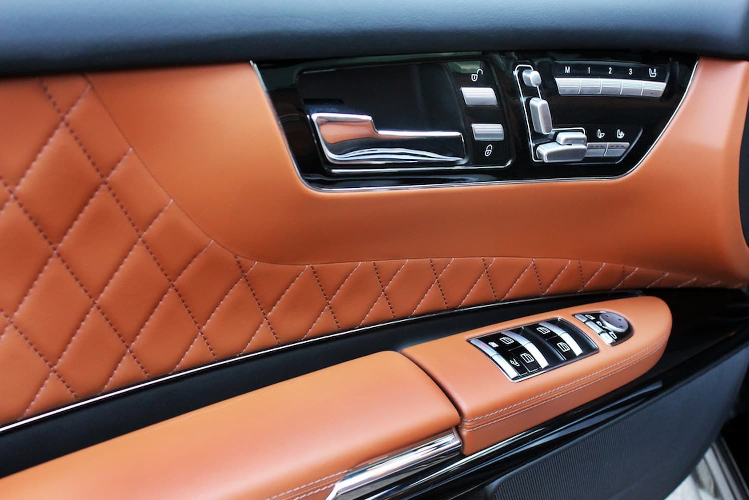 A Close up Of a Car Door with Brown Leather and Chrome Trim — Chinderah Smash Repairs in Chinderah, NSW