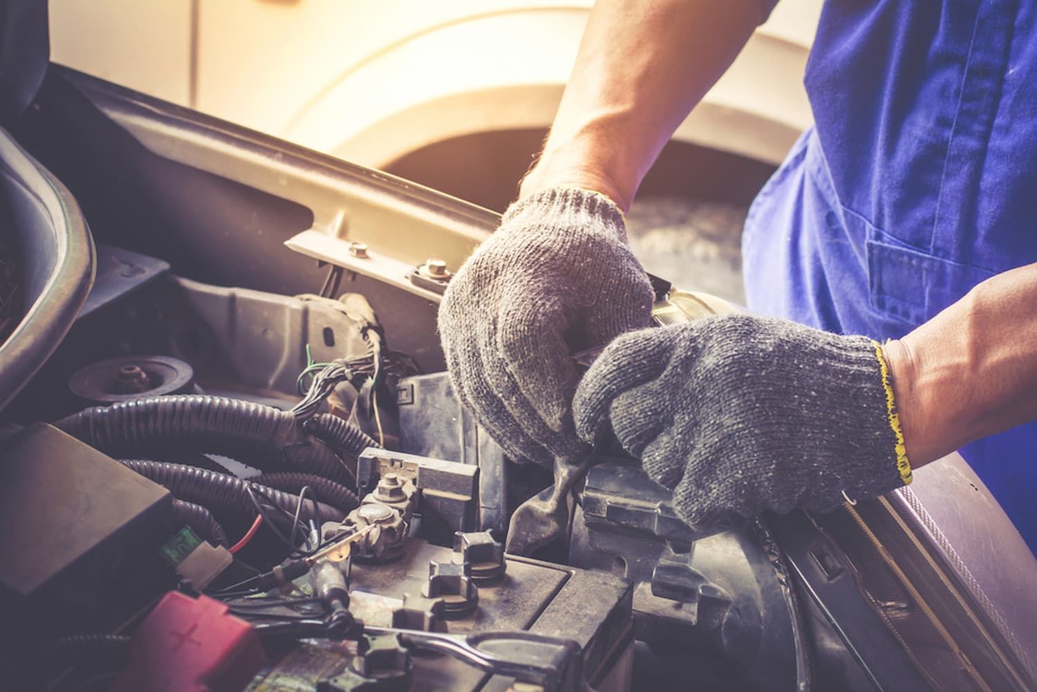 A Man Is Working on The Engine of A Car — Chinderah Smash Repairs in Chinderah, NSW