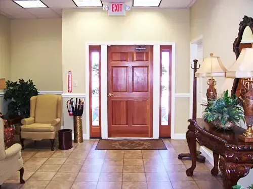 a hallway with an exit sign above the door