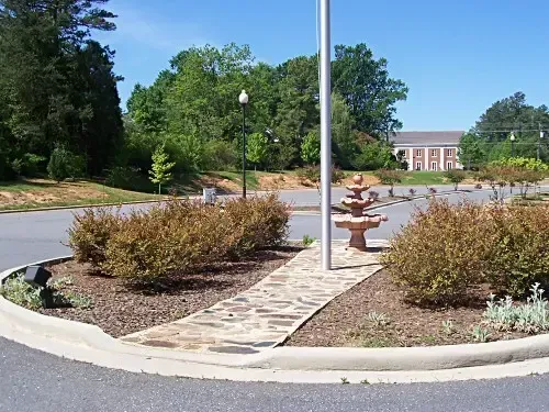 a flag pole in the middle of a parking lot