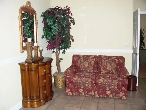 a living room with a couch and a mirror