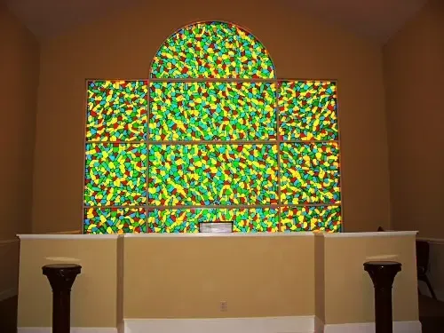 a church with a stained glass window on the wall .