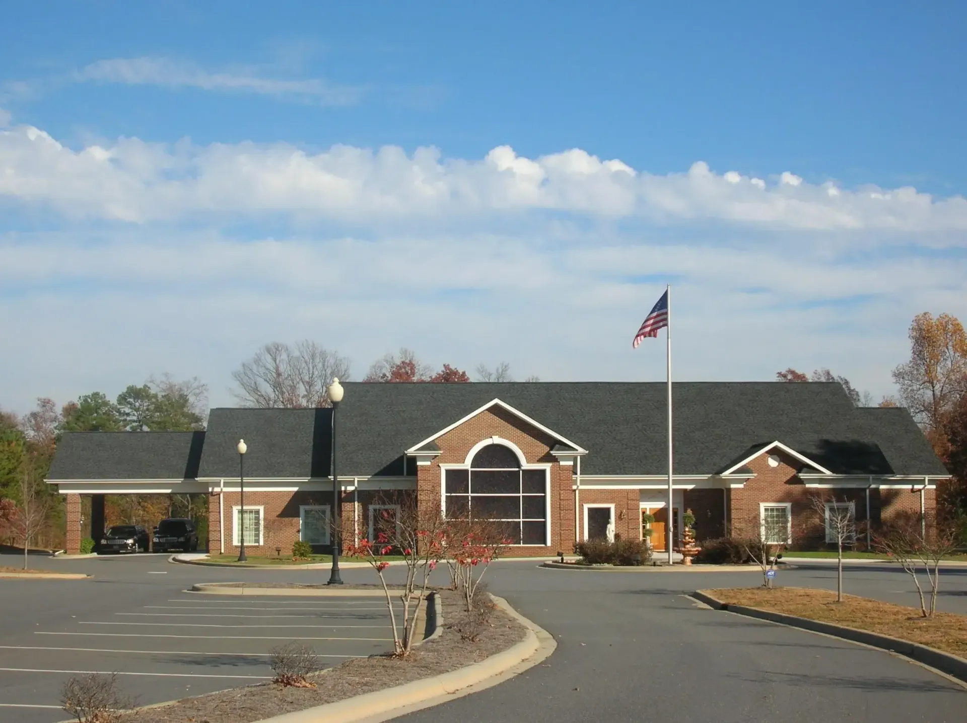 a large brick building with an american flag in front of it