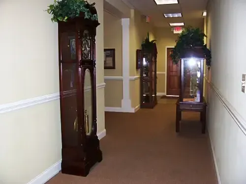 a hallway with a large grandfather clock in the middle