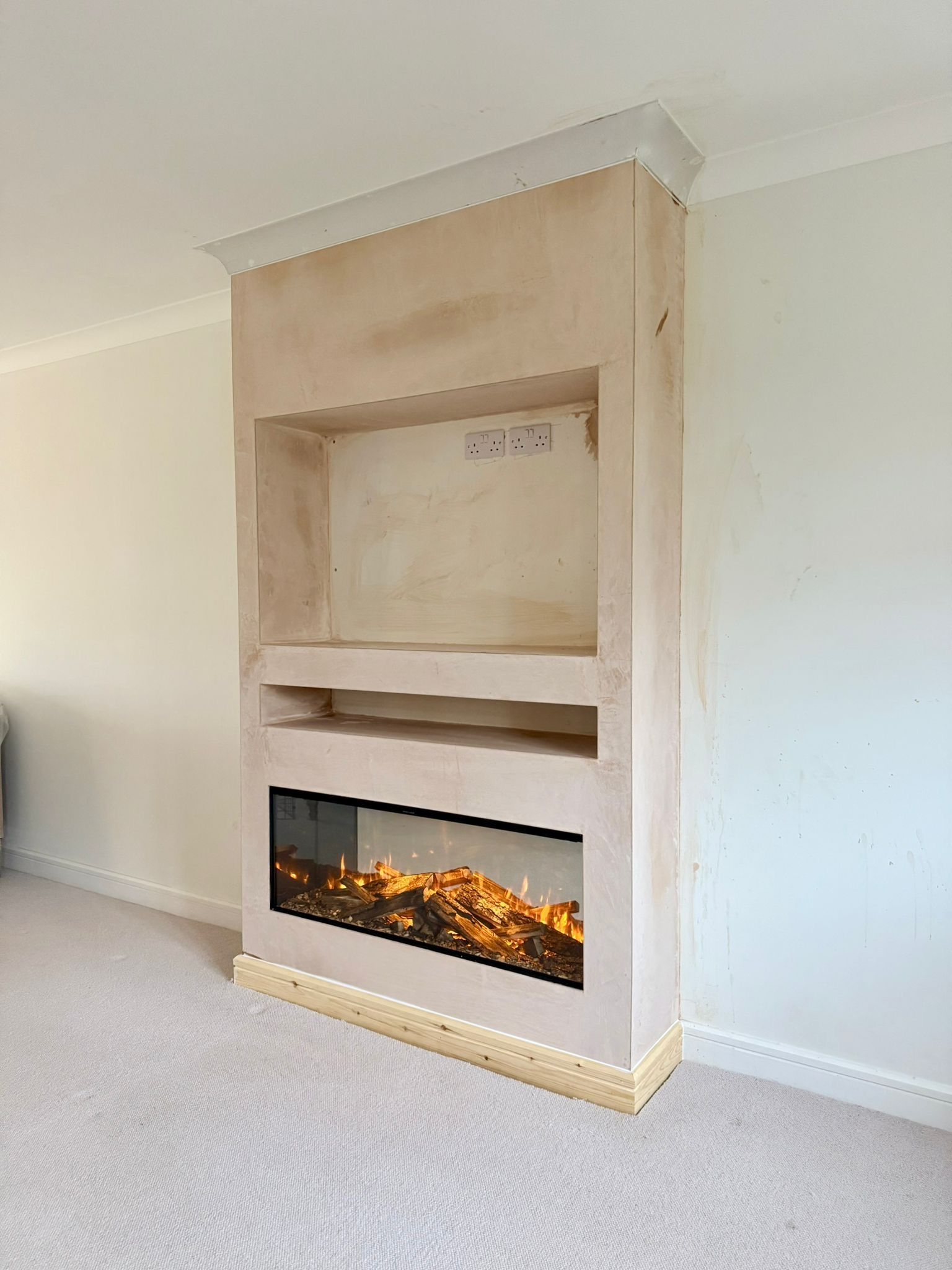 half finished media wall with electric fire