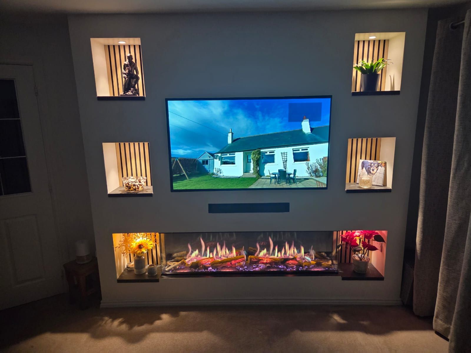 Charlton & Jenrick Luminosa 150 fire in a media wall below a 55 inch tv