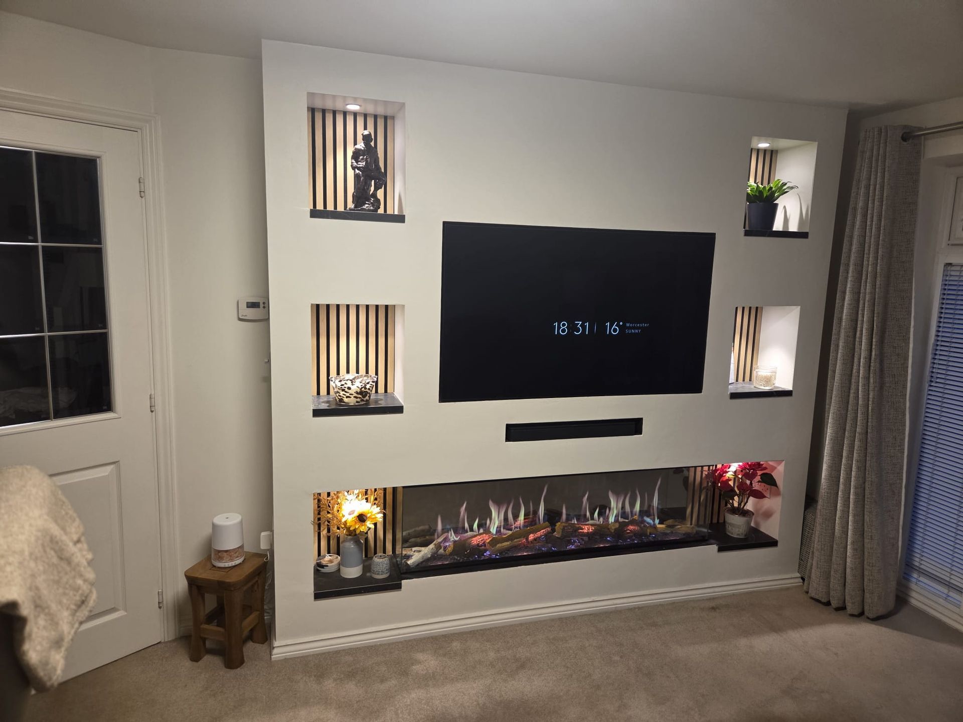 luminosa 150 electric fire in a media wall with shelves either side of it