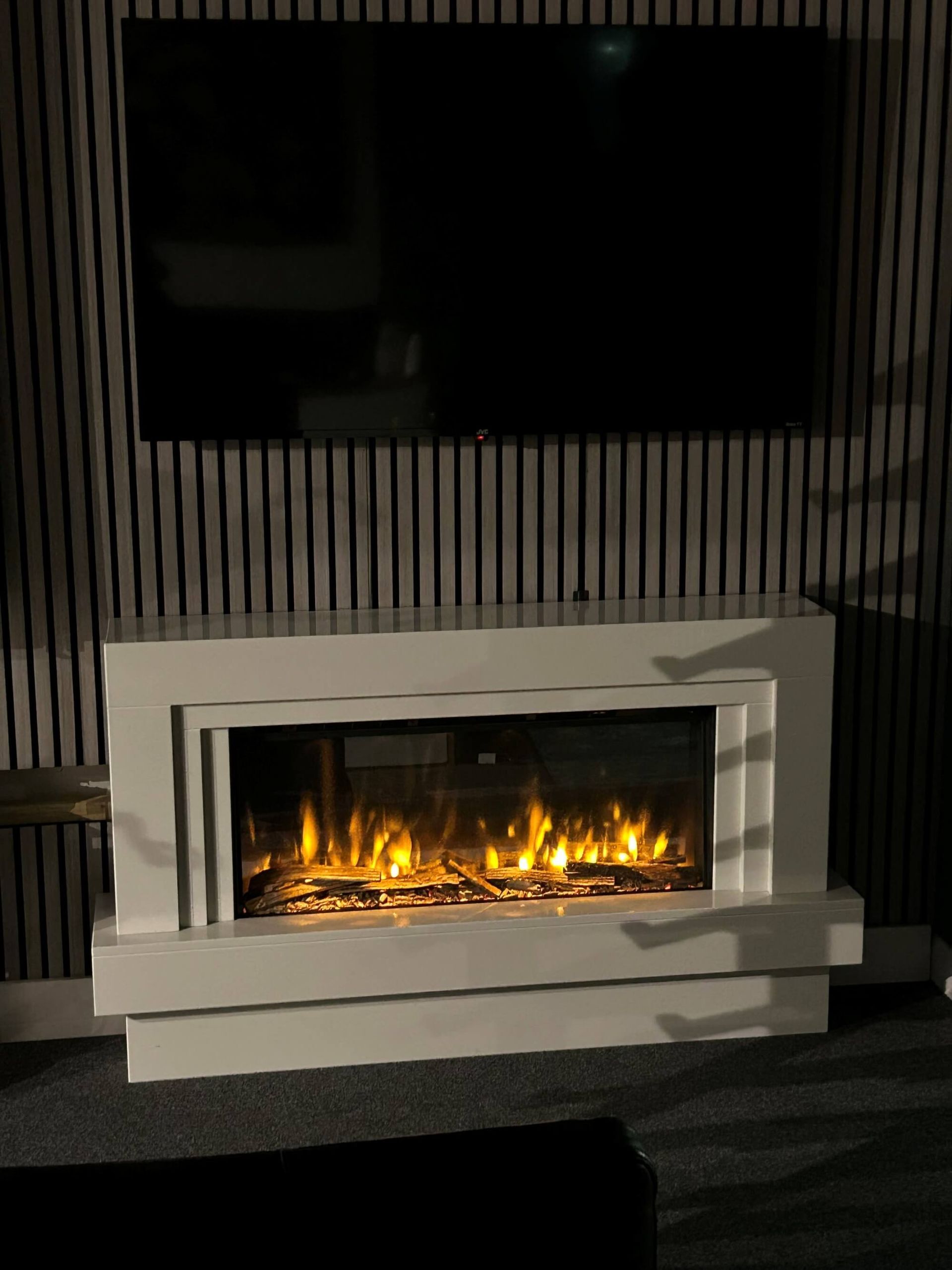 stone fireplace with slim electric fire on dispaly in warwickshire