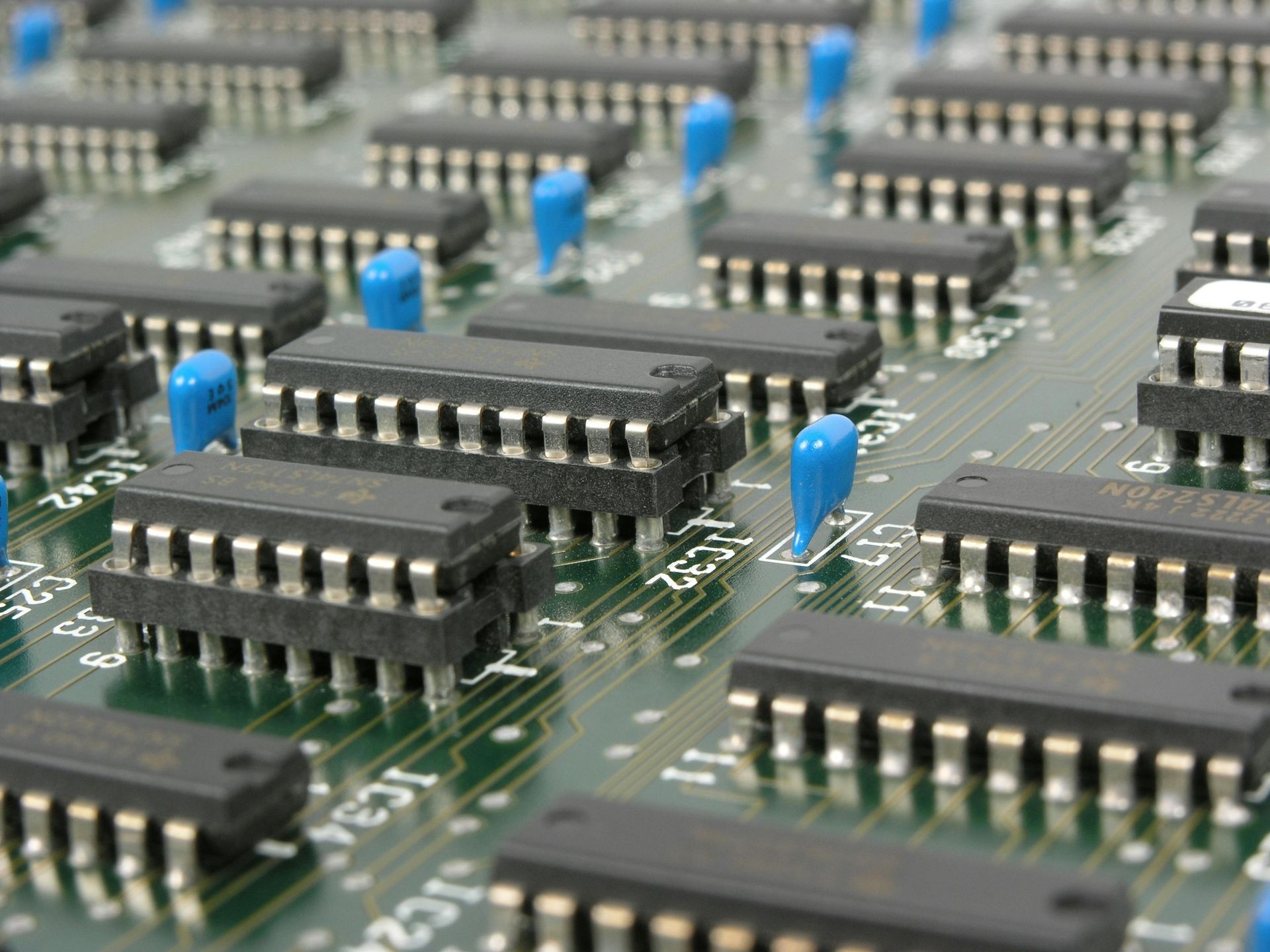 A close up of a circuit board with a lot of microchips on it