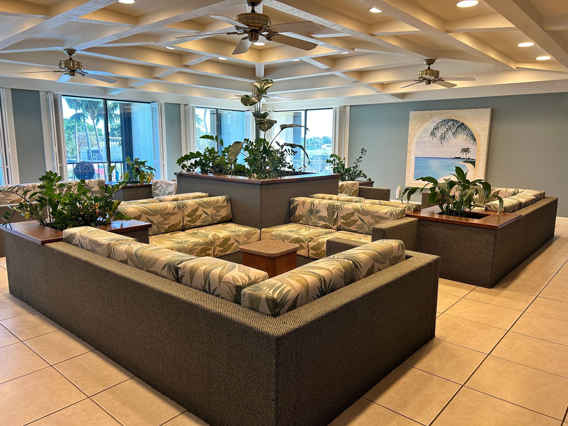 A living room with a lot of furniture and a ceiling fan