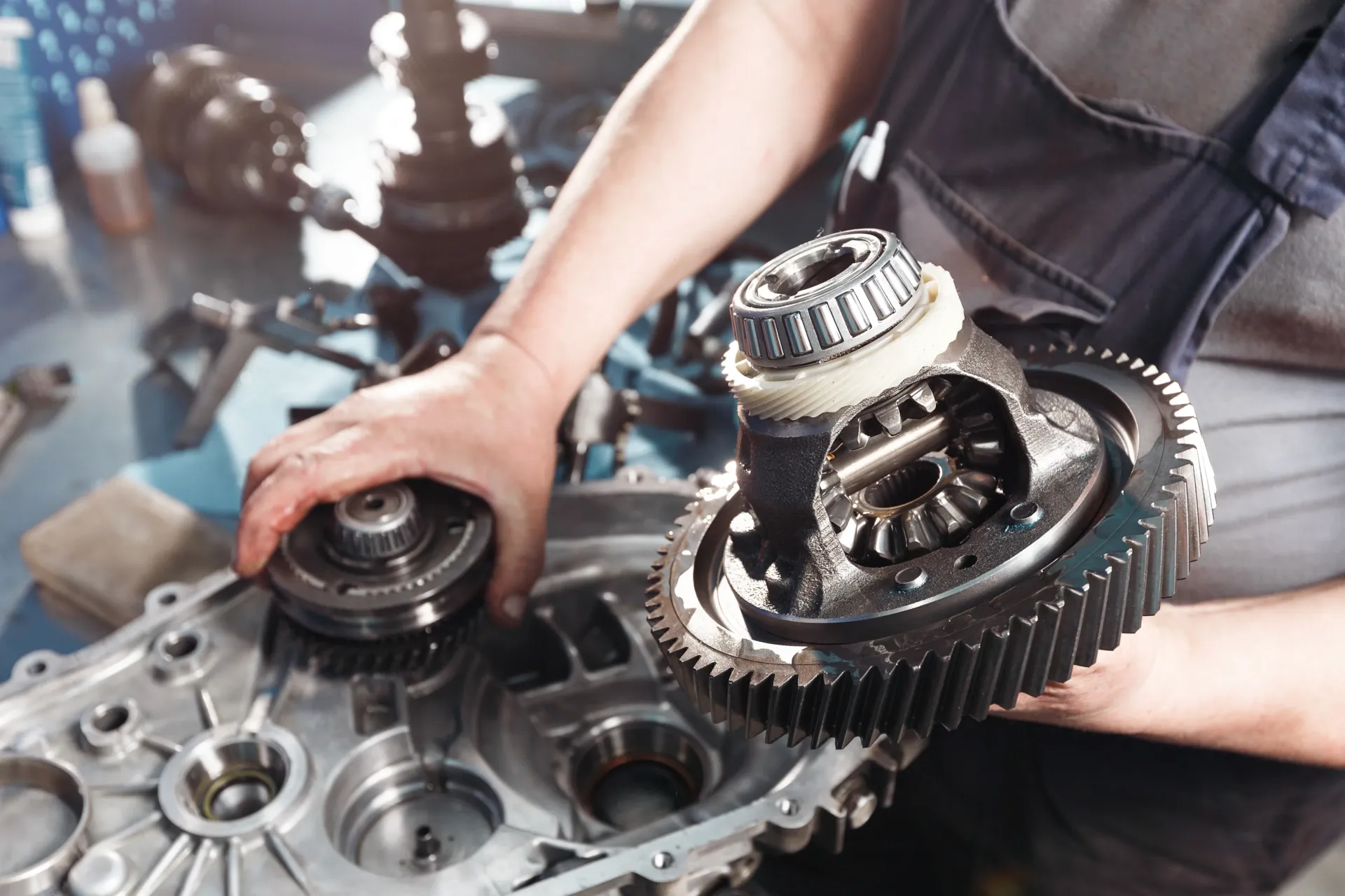 A man is working on a gearbox in a garage | German Auto of Santa Maria
