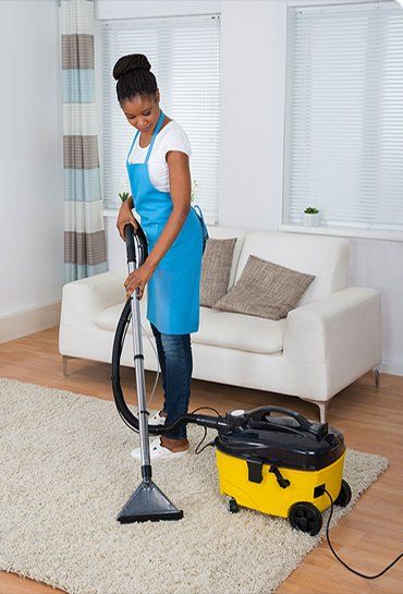 Women Doing A Vacuum Cleaning