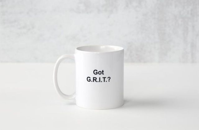 A white coffee mug with the words `` got grit '' written on it