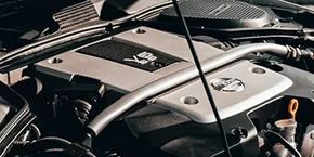 A close up of a car engine with the hood open.