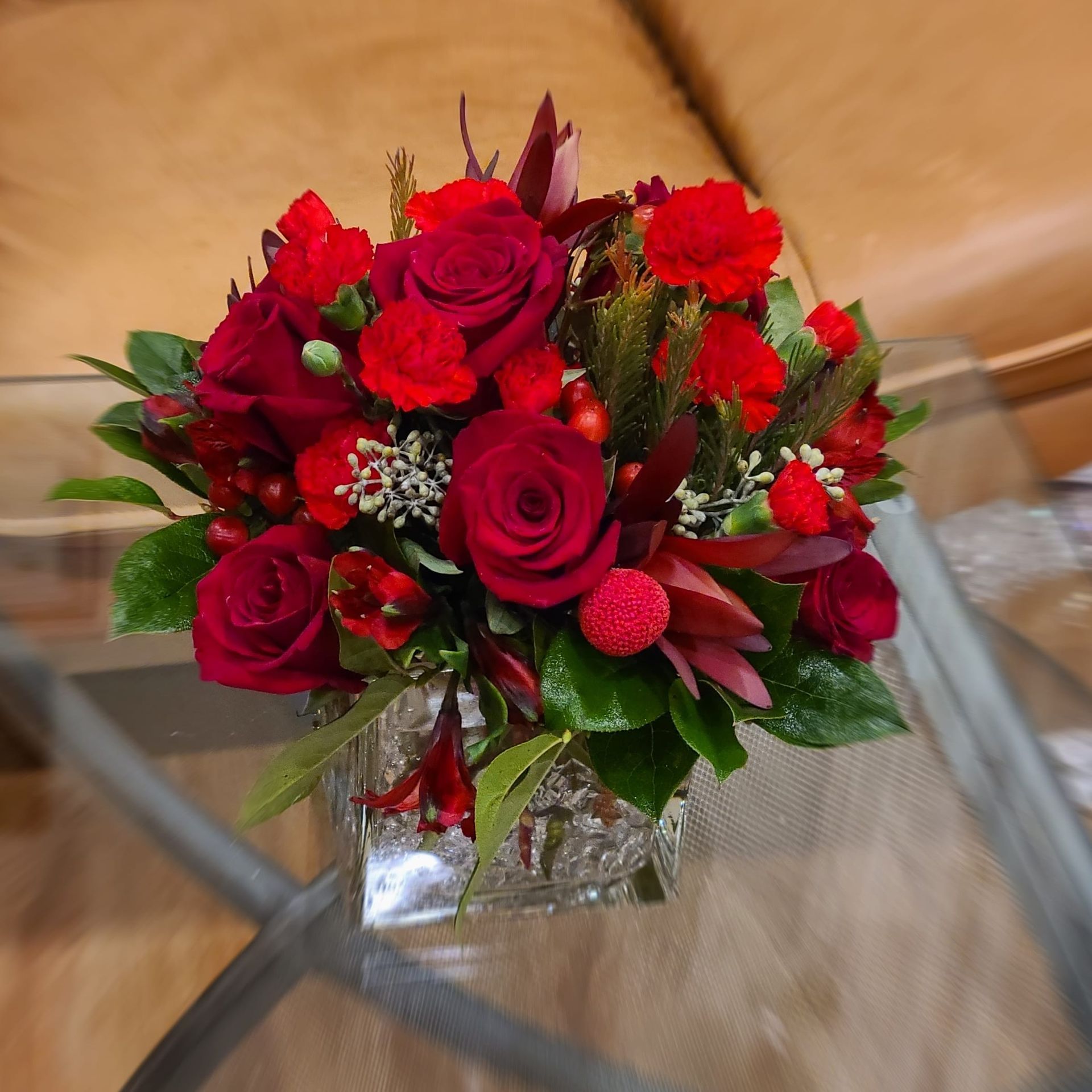 A bouquet of flowers including sunflowers roses and carnations