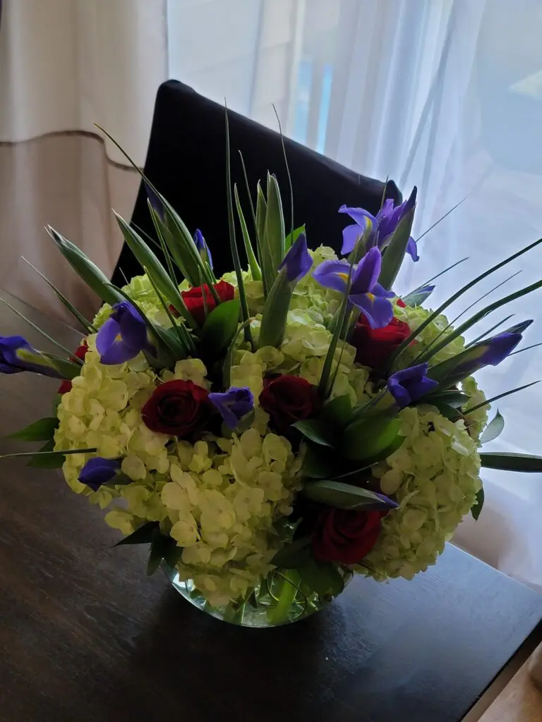 A vase filled with flowers is sitting on a table.