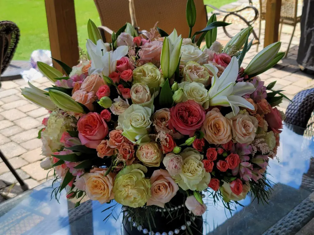 A vase filled with flowers is sitting on a table.
