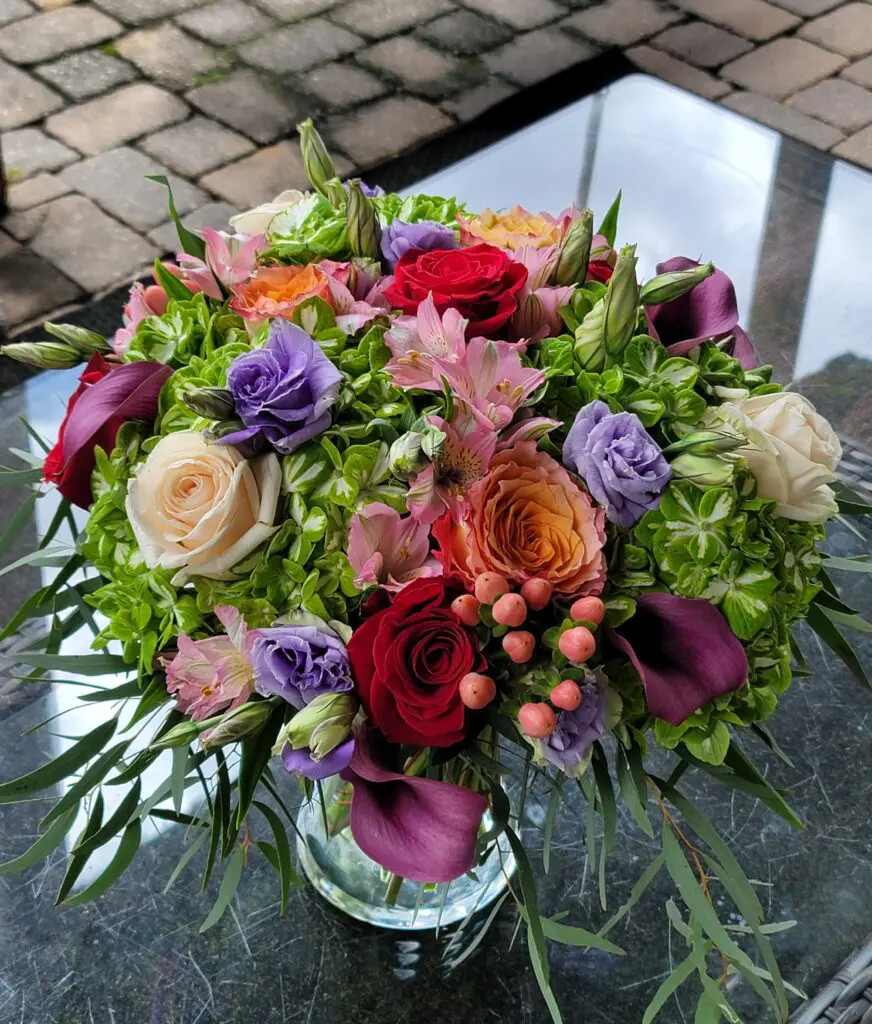 A vase filled with flowers is sitting on a table.
