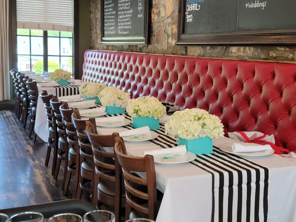 A long table with a black and white striped table runner