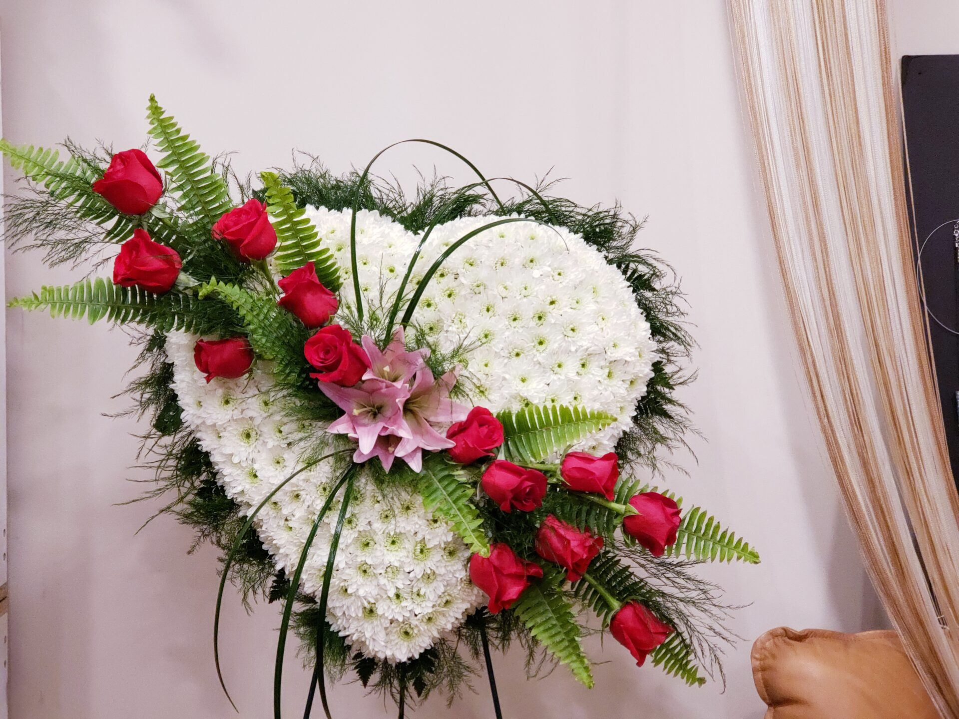 A heart made of white flowers and red roses