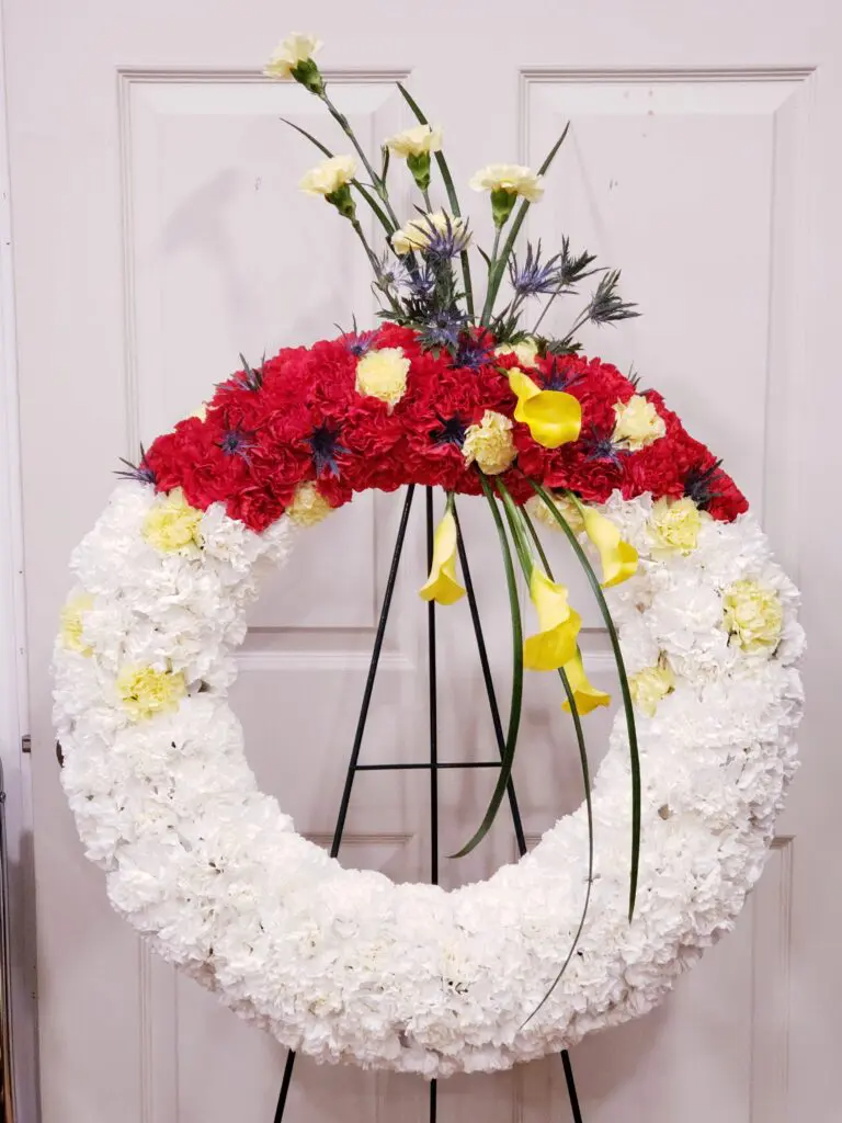 A wreath made of red white and yellow flowers