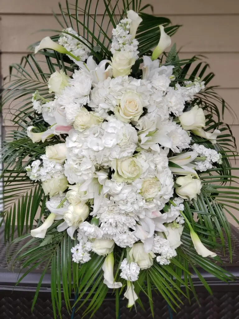 A large bouquet of white flowers is sitting on a table.