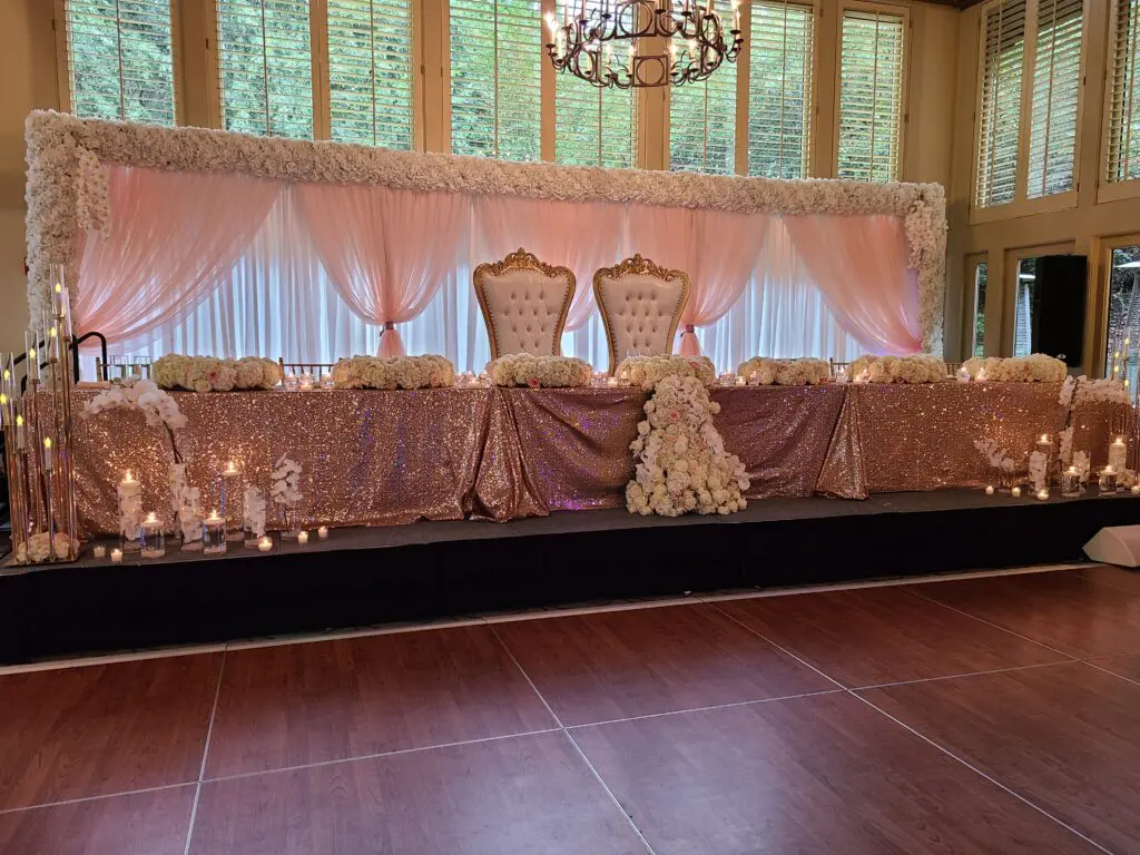 A long table with two chairs and candles on it in a room.
