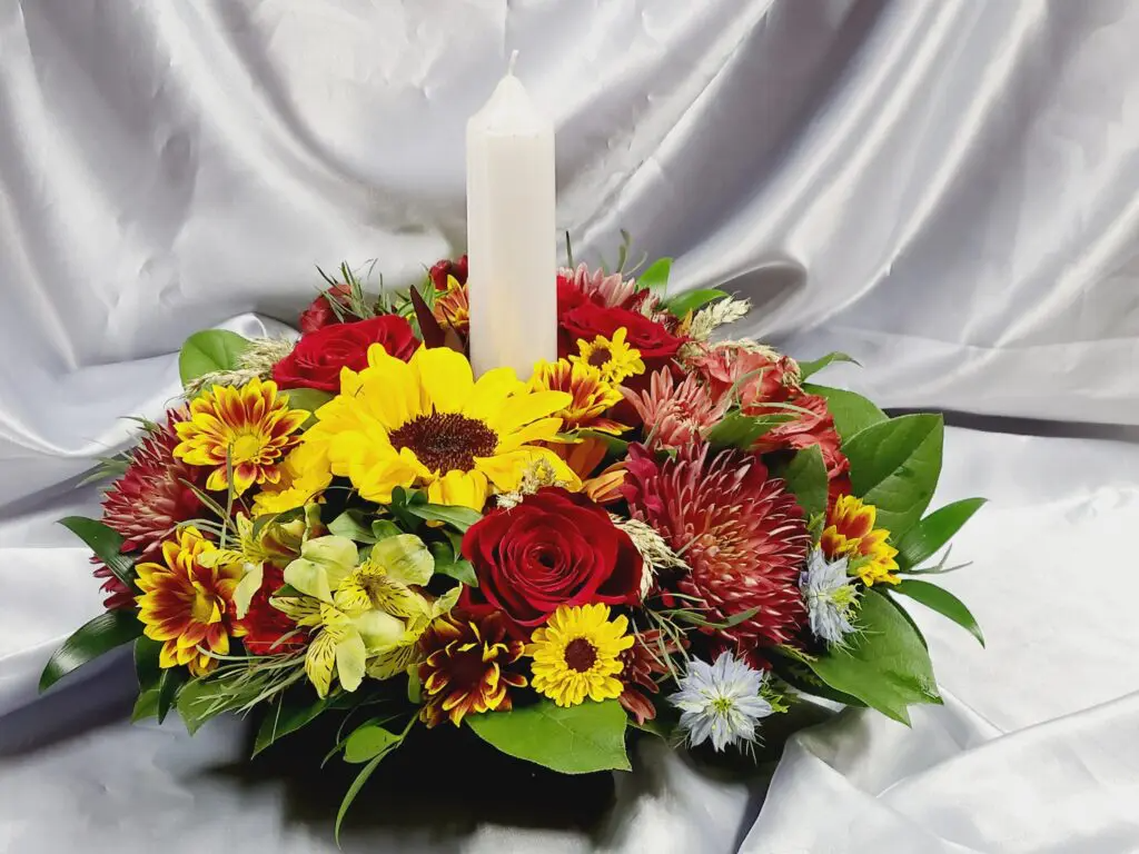 A bouquet of flowers with a candle in the middle