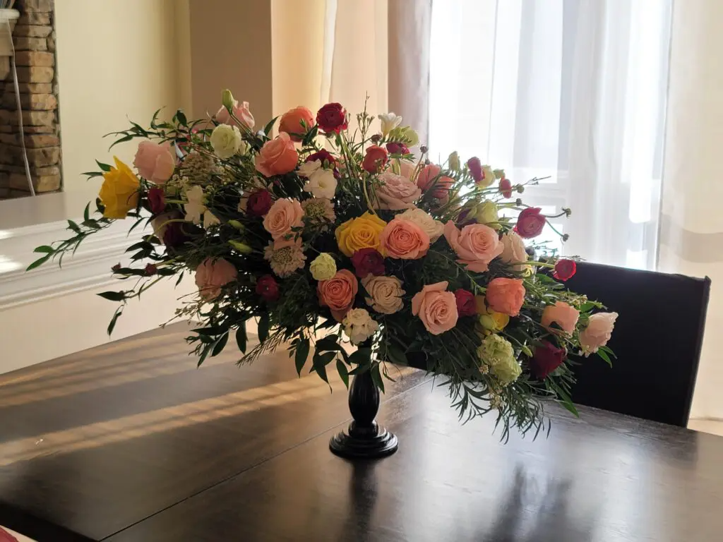 A vase filled with flowers is sitting on a table.