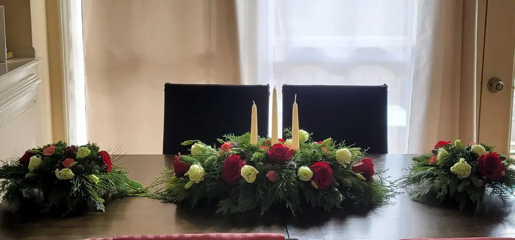 A dining room table with flowers and candles on it