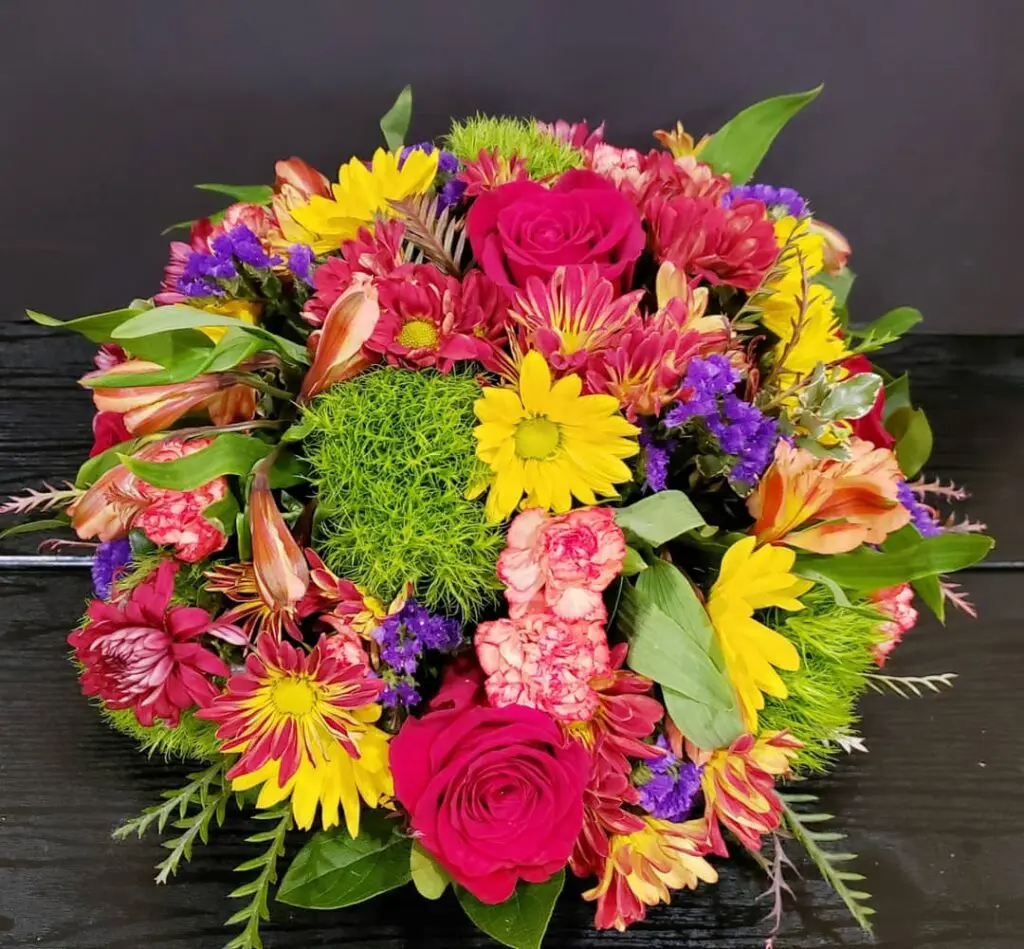 A bunch of colorful flowers are sitting on a table