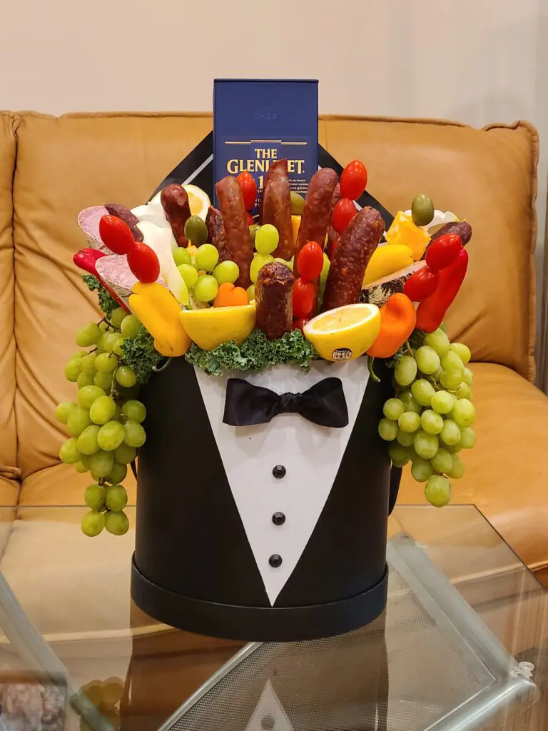 A tuxedo shaped box filled with fruits and vegetables