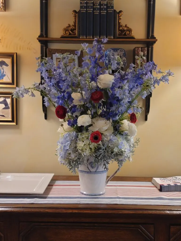 A vase filled with blue and white flowers sits on a table