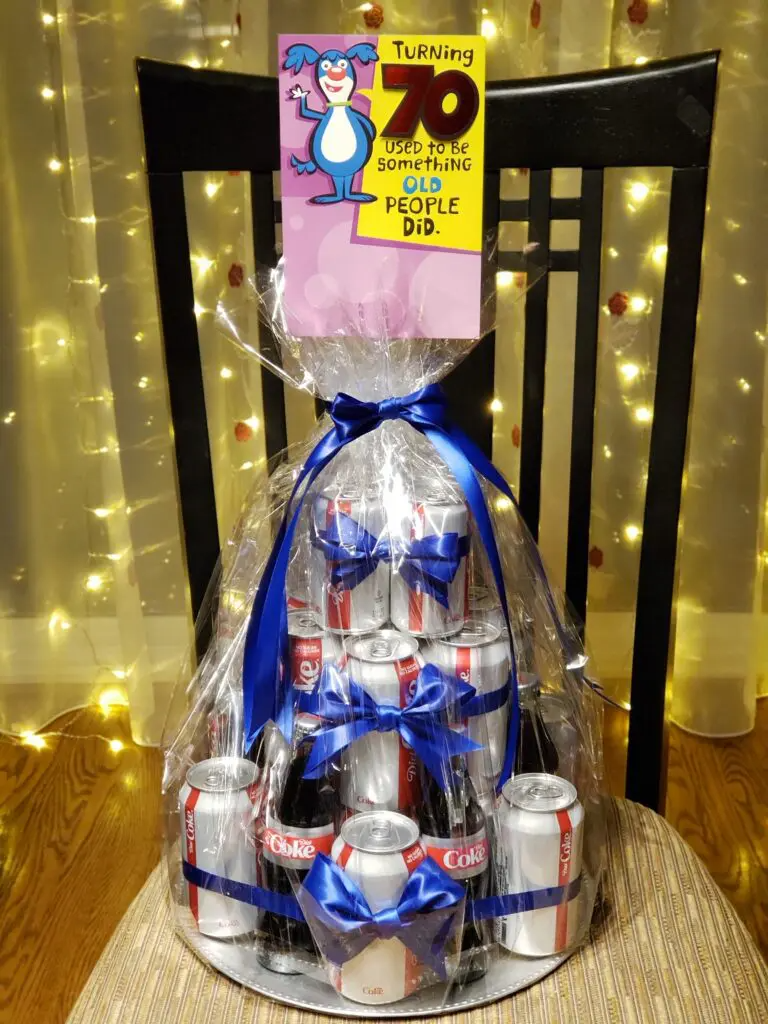 A birthday cake made out of soda cans is sitting on a chair.