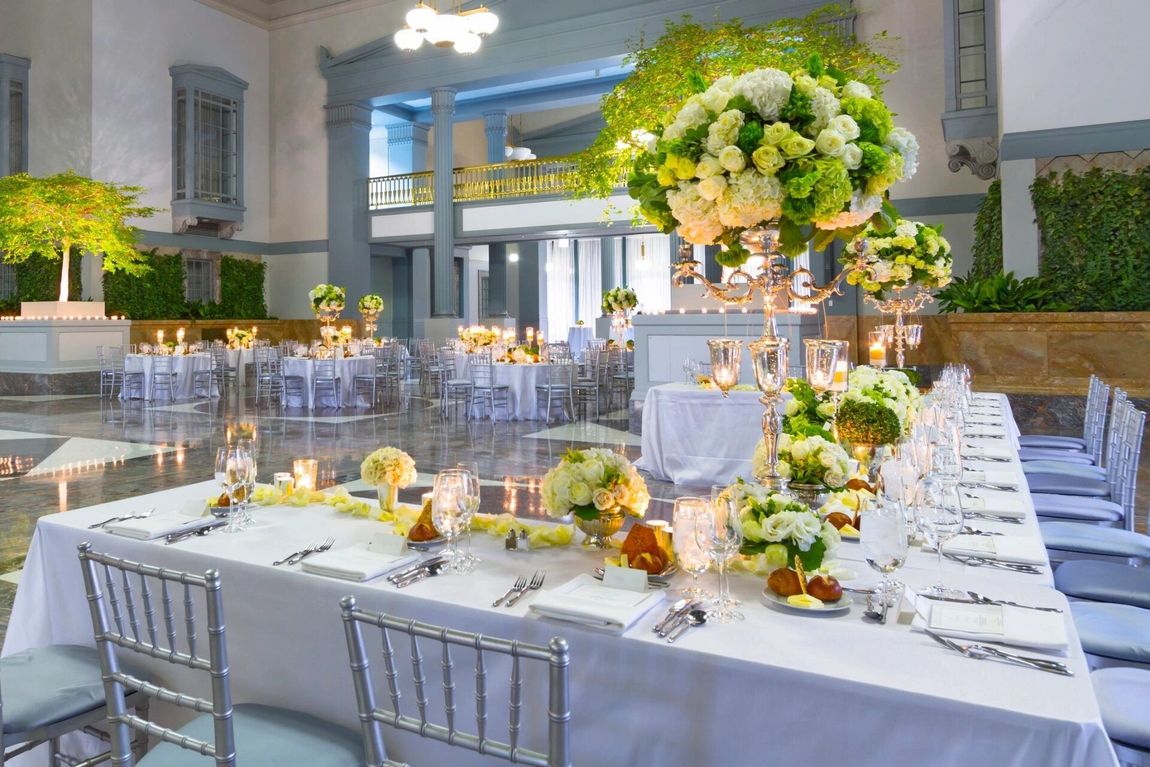 A long table with flowers and candles on it