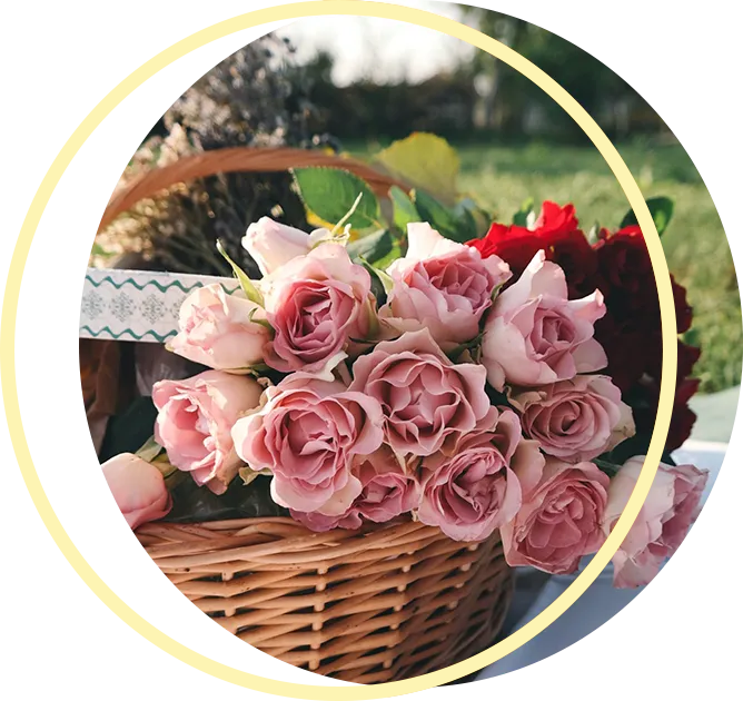 A wicker basket filled with pink roses and red roses