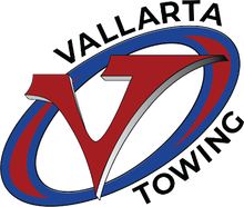 Vallarta Towing logo: Red "V" inside blue and red oval, black text: VALLARTA TOWING.