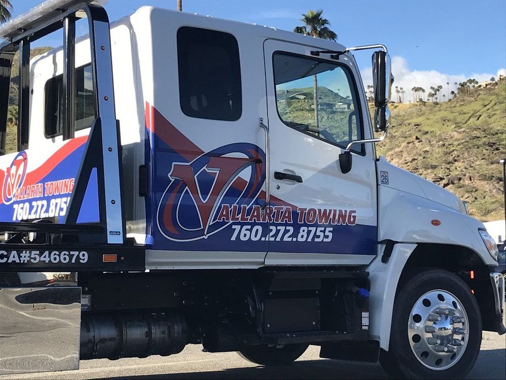 White tow truck with blue and red logo, 