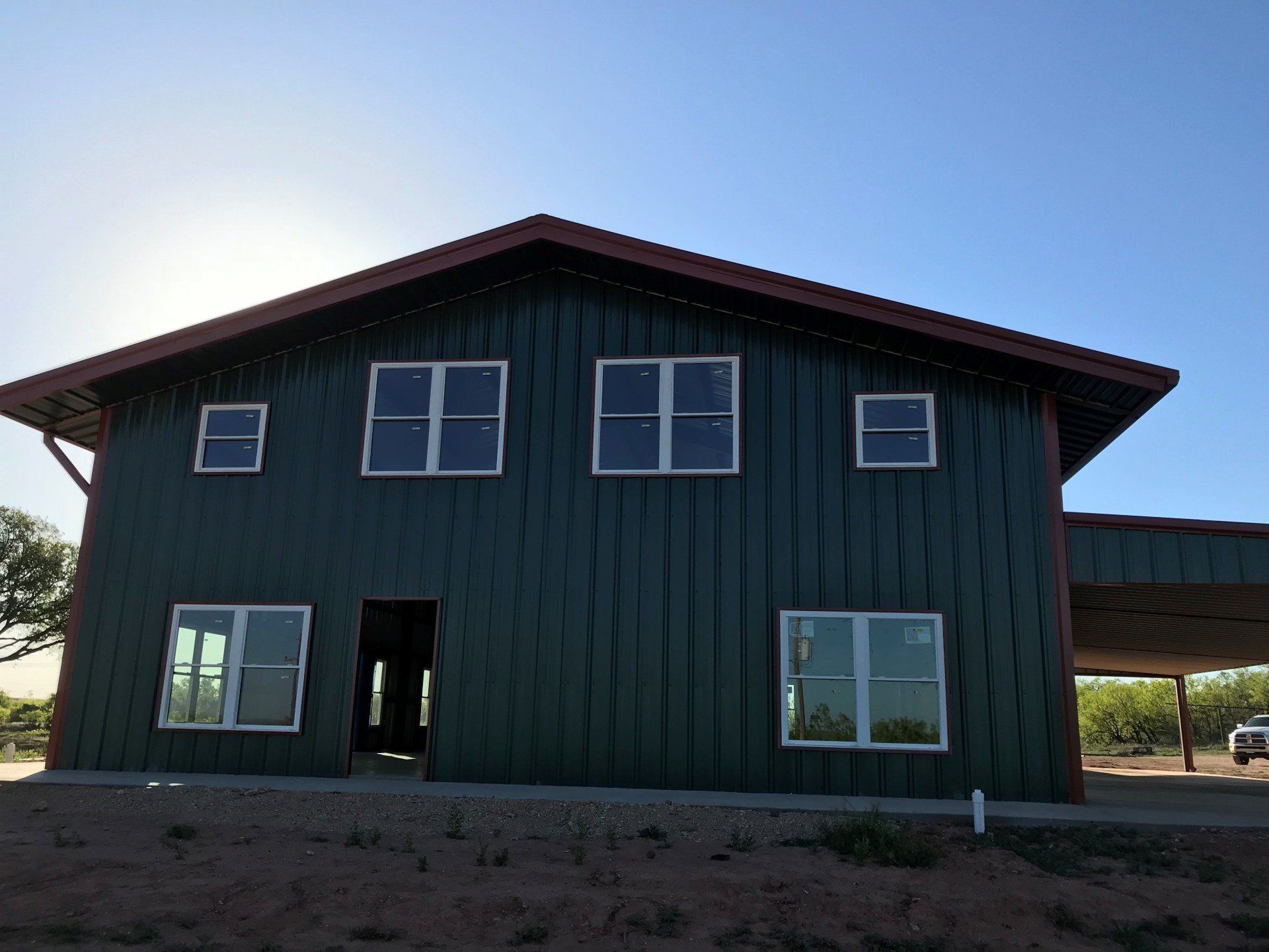 A large green house with a lot of windows