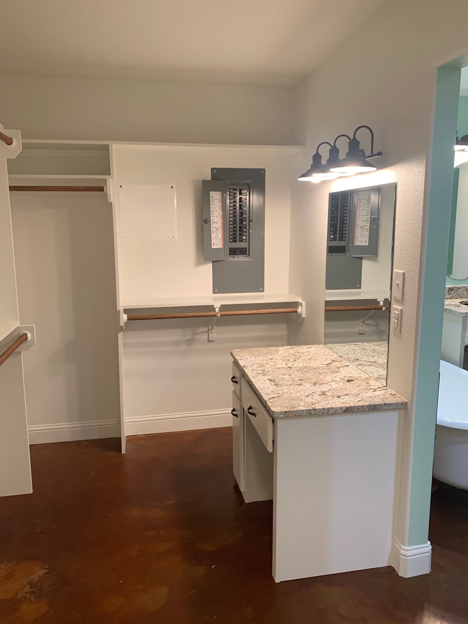A bathroom with a sink , mirror and closet.