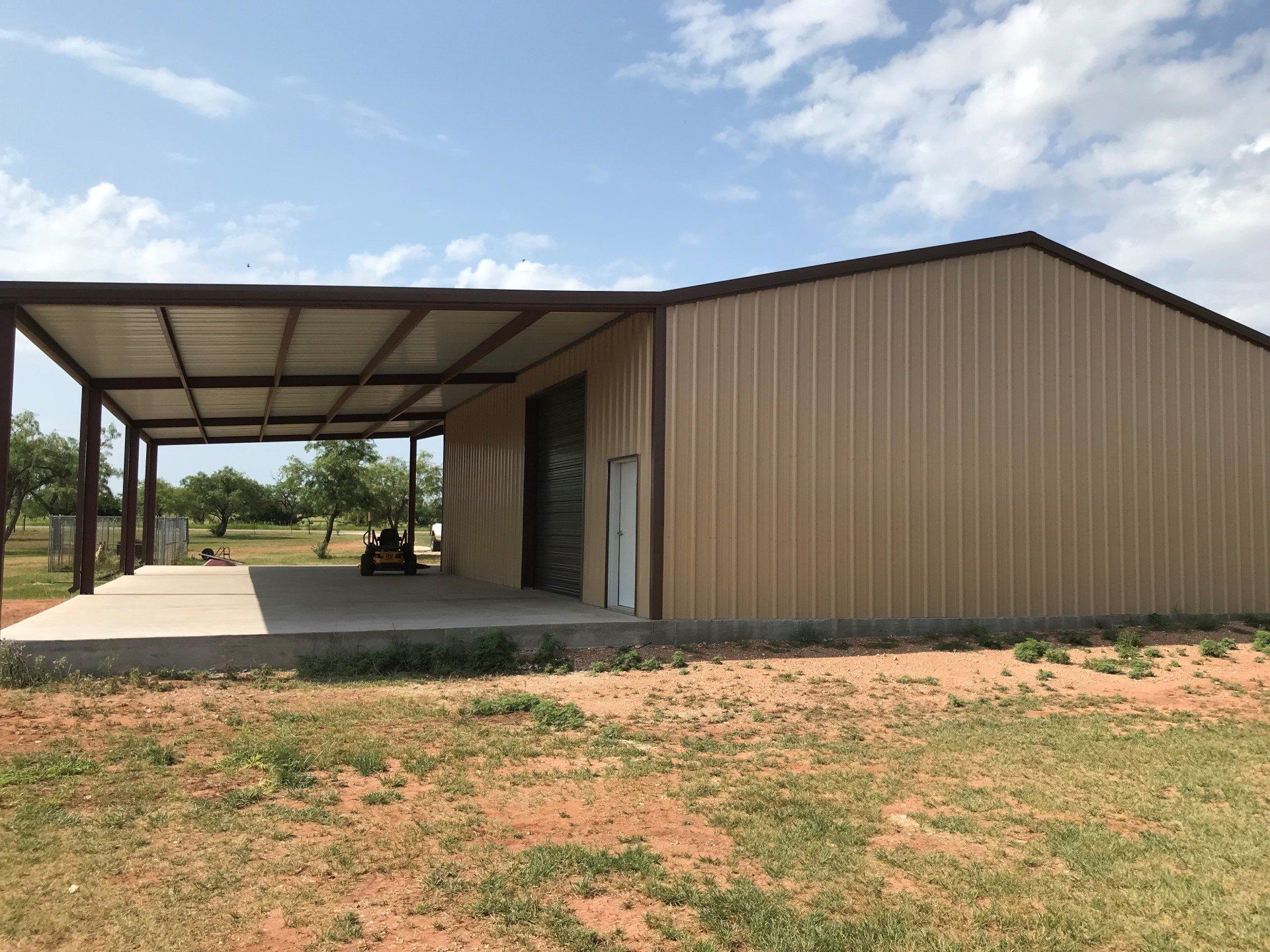A large metal building with a carport underneath it.