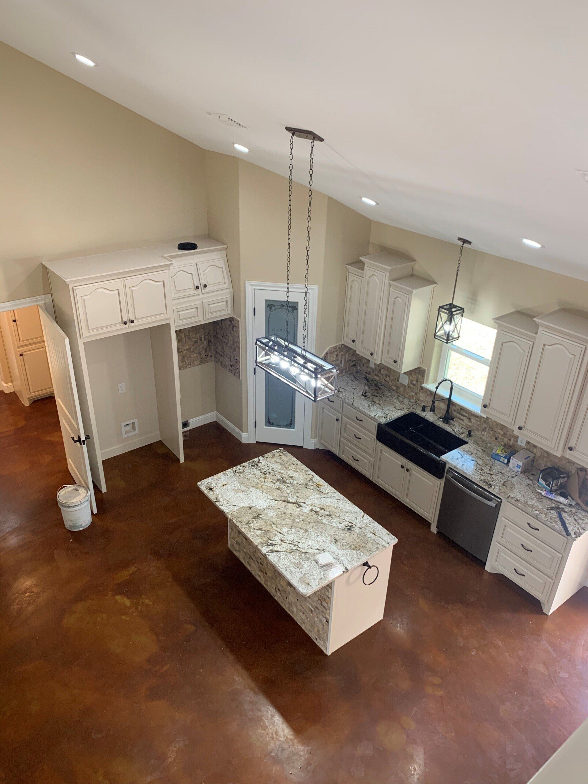 An aerial view of a kitchen with a large island in the middle.