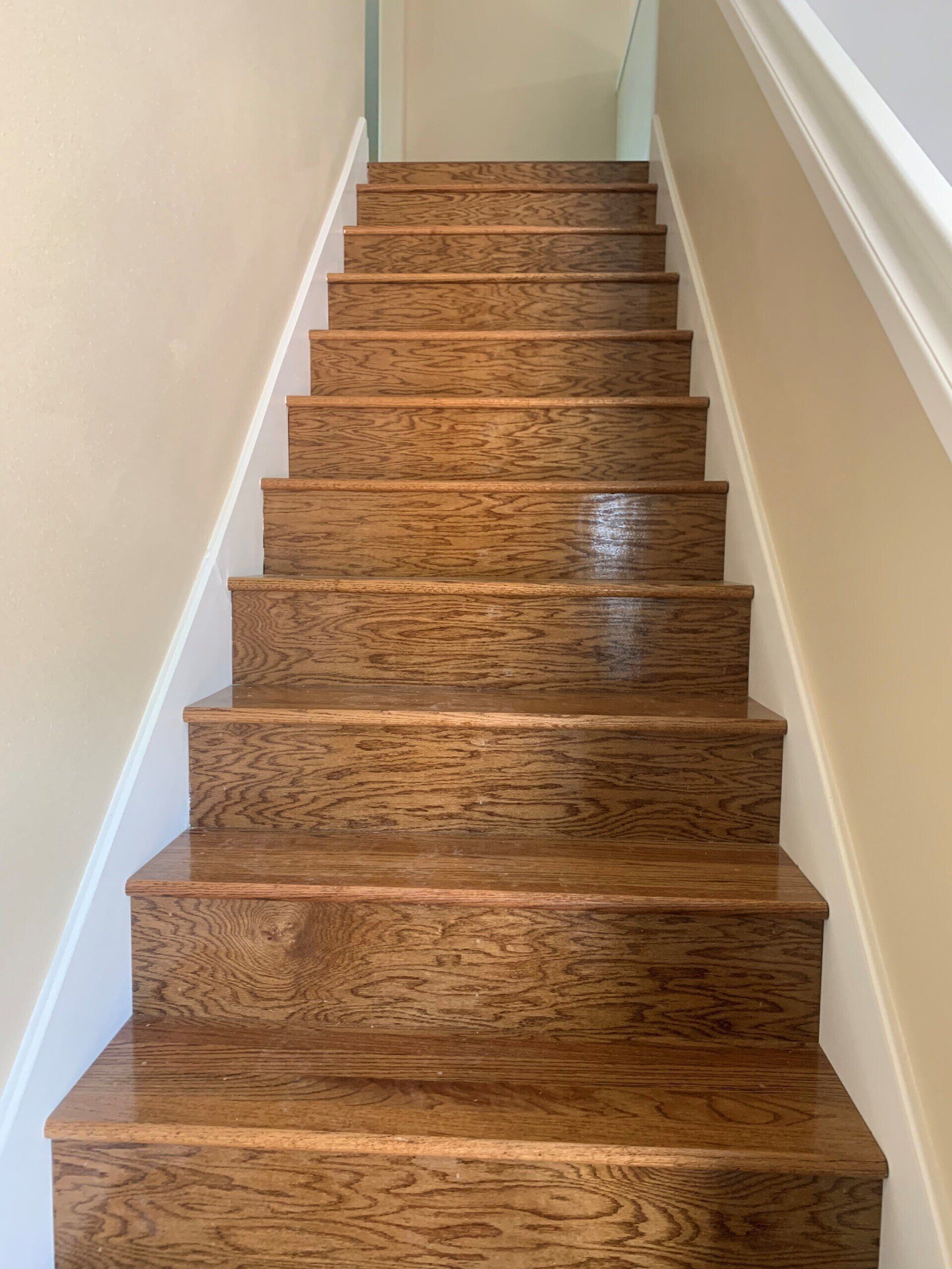 A set of wooden stairs leading up to the second floor of a house.