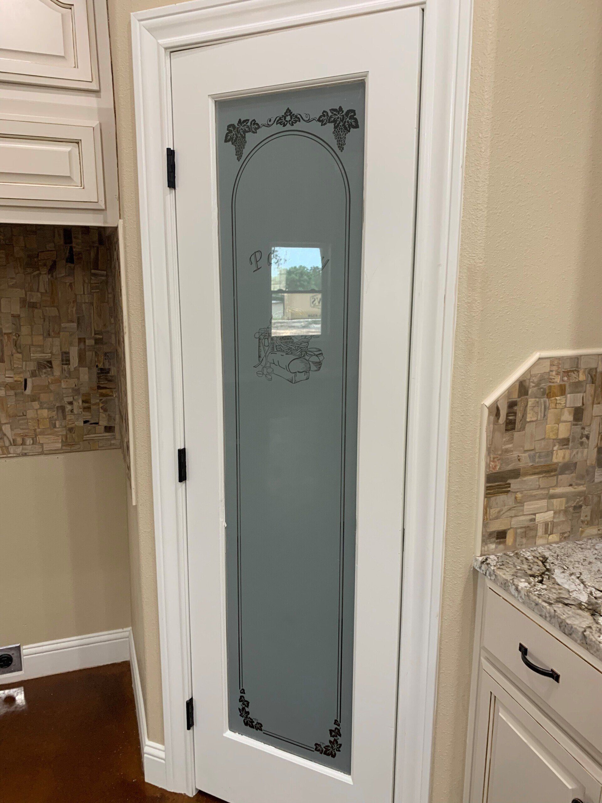 A white door with a stained glass design on it