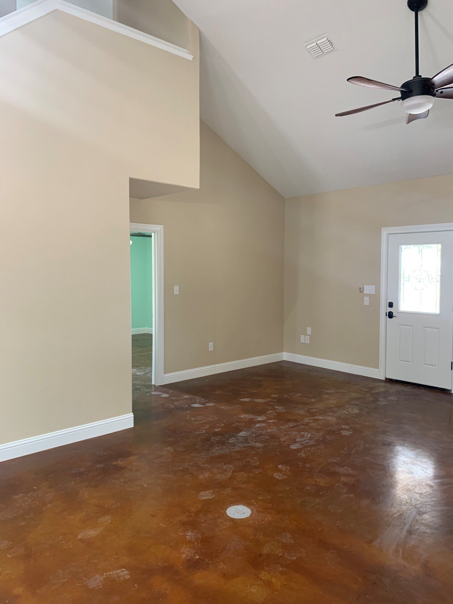 A living room with a vaulted ceiling and a ceiling fan