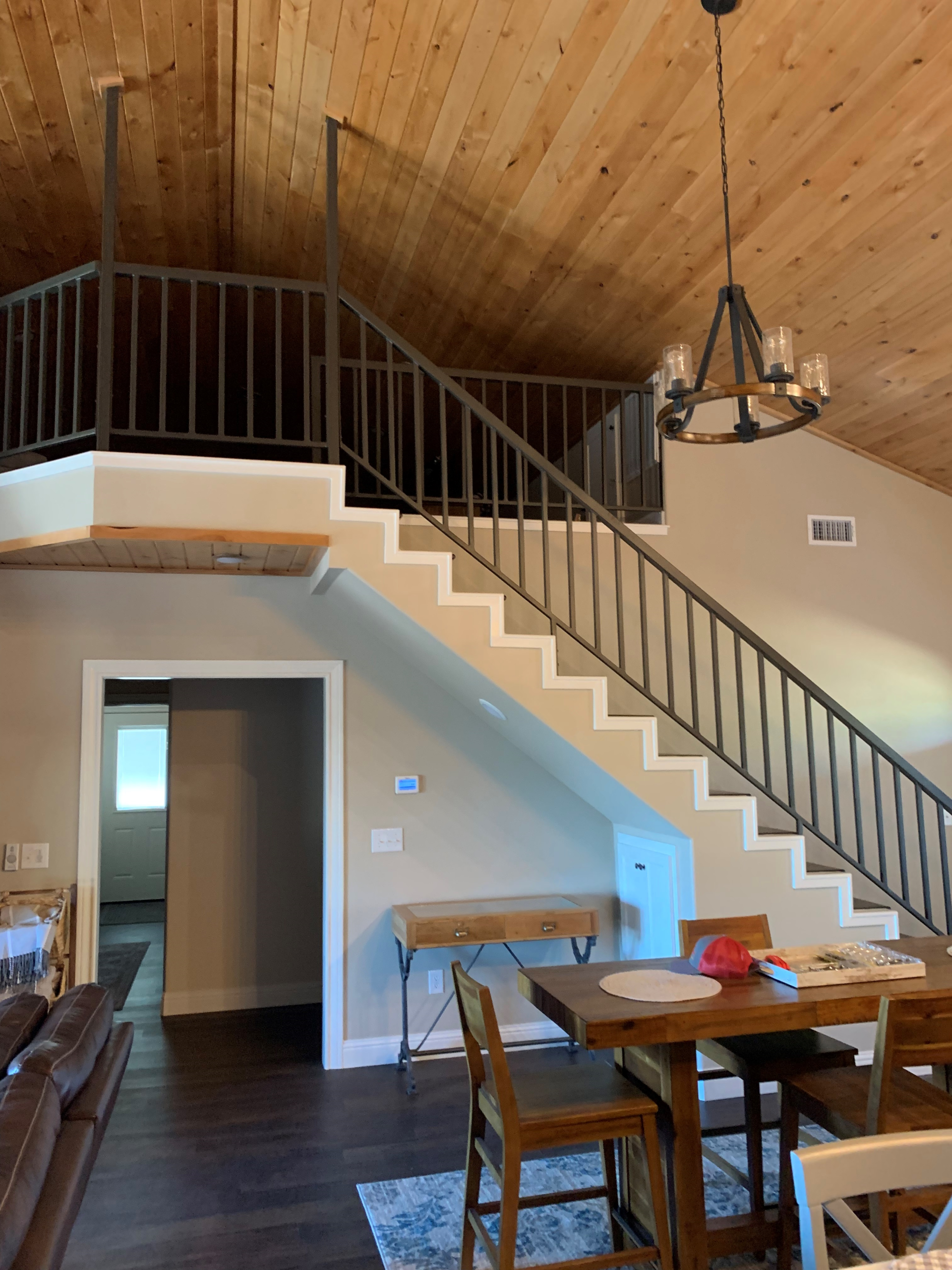 A living room with stairs leading up to the second floor