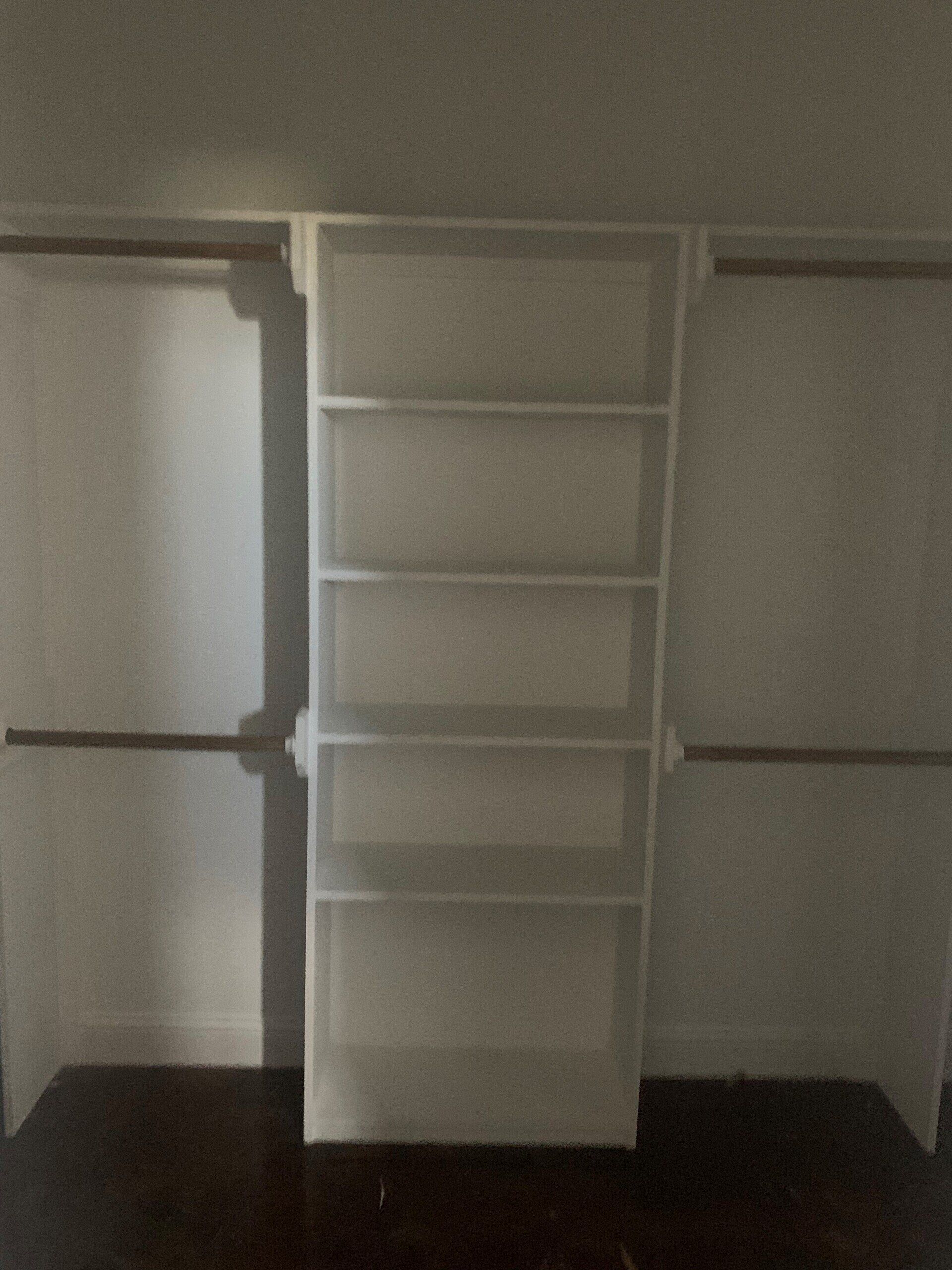 A closet with shelves and hangers in it