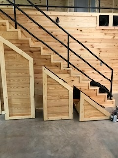 A set of wooden stairs with a metal railing