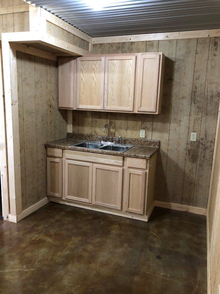 A kitchen with wooden cabinets and a sink.