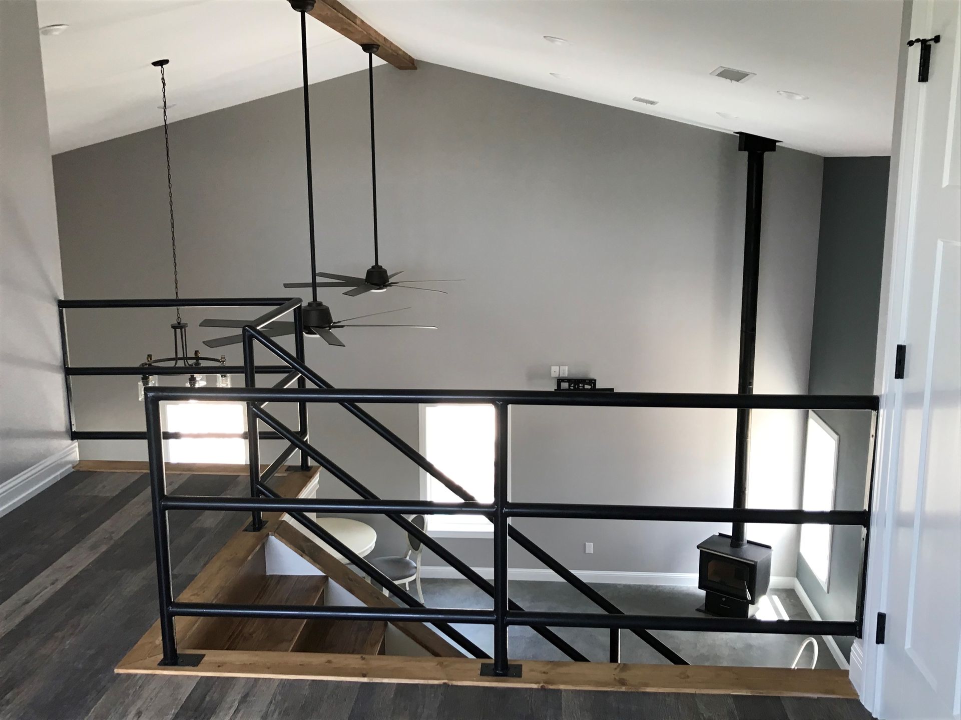 A staircase in a house with a black railing